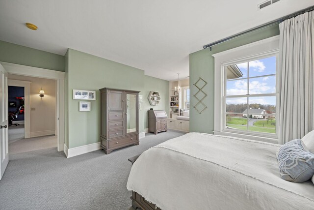 bedroom with a chandelier, baseboards, multiple windows, and light colored carpet