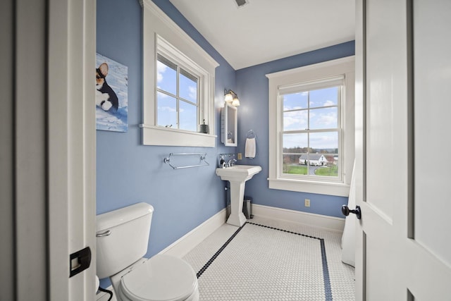 bathroom featuring toilet and baseboards