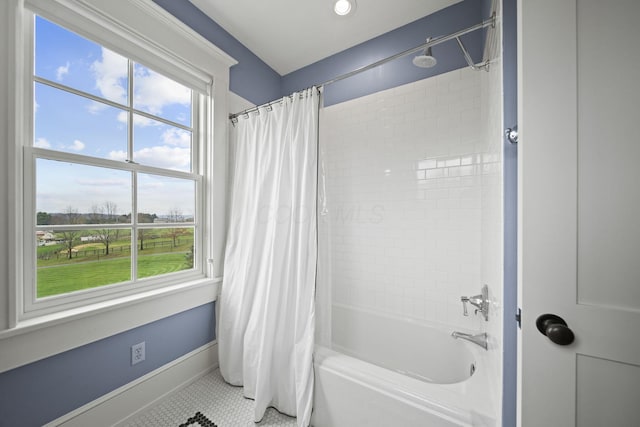 full bath with tile patterned flooring, shower / tub combo, and baseboards