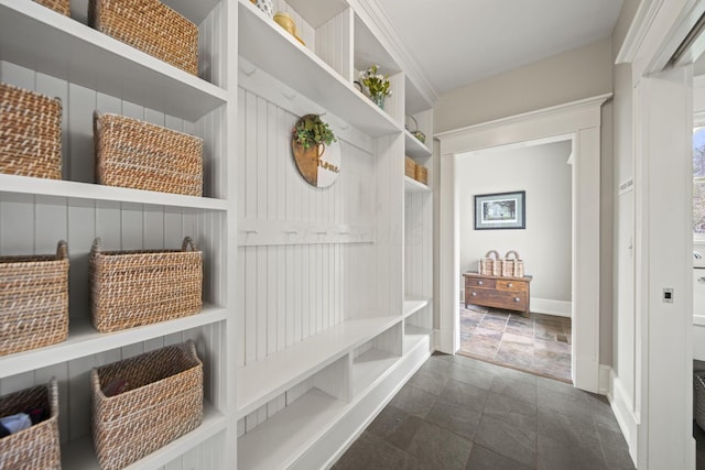 mudroom featuring stone finish floor and baseboards