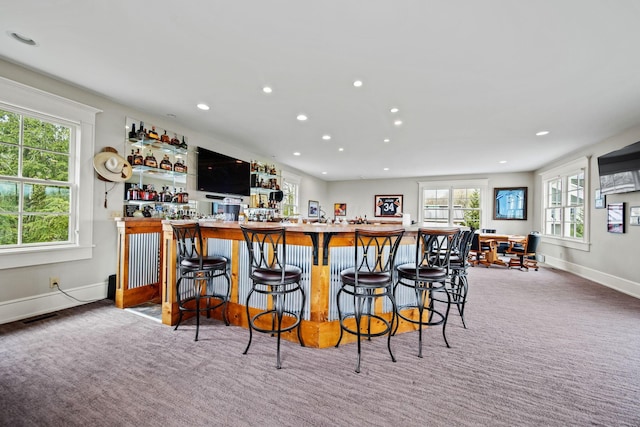 bar featuring baseboards, recessed lighting, carpet flooring, visible vents, and bar