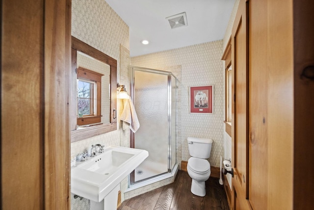 full bathroom with a sink, toilet, a shower stall, and wallpapered walls
