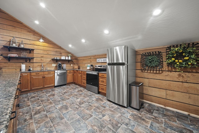 kitchen featuring open shelves, appliances with stainless steel finishes, dark stone counters, wood walls, and lofted ceiling