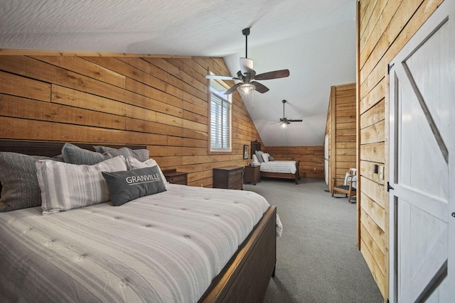 bedroom featuring wooden walls, vaulted ceiling, a ceiling fan, and carpet floors