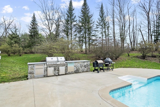 pool featuring a patio area, grilling area, a yard, and an outdoor kitchen