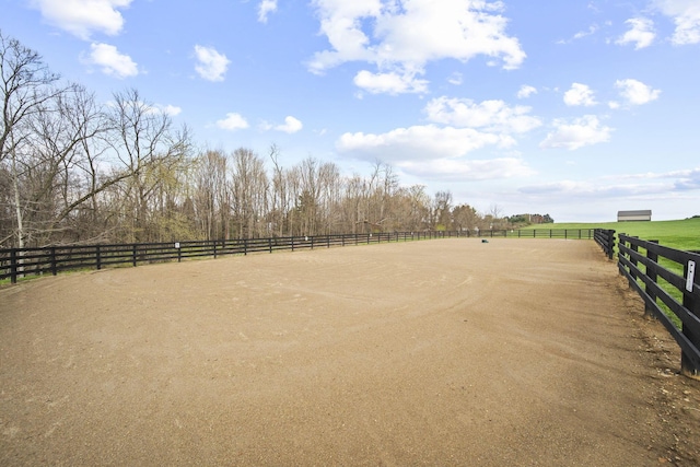 view of property's community with an enclosed area and a rural view