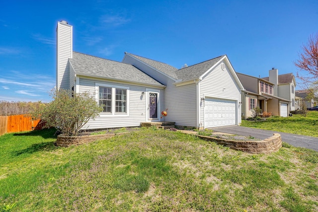 2655 Cross Creek Ave, Lancaster, OH 43130 - view of front facade featuring a front yard, fence, an attached garage, and aphalt driveway