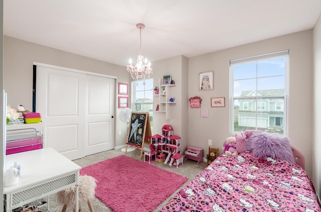bedroom with light carpet, a notable chandelier, a closet, and multiple windows