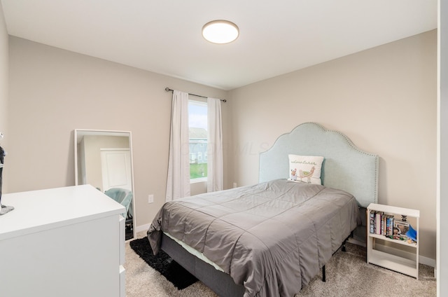 carpeted bedroom featuring baseboards