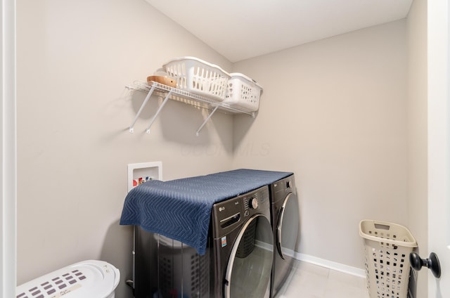 laundry area with independent washer and dryer, tile patterned flooring, baseboards, and laundry area