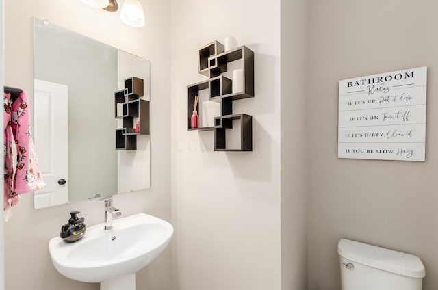 half bathroom with a sink and toilet