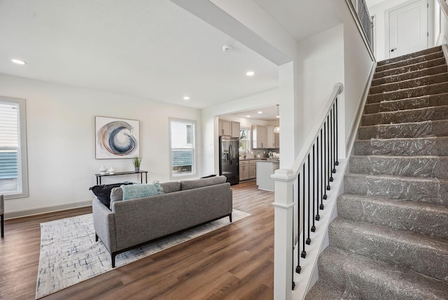 living room with baseboards, recessed lighting, wood finished floors, and stairs