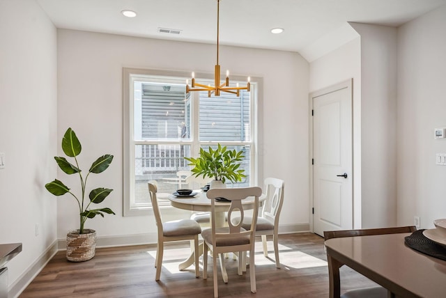 dining room featuring wood finished floors, an inviting chandelier, baseboards, and recessed lighting