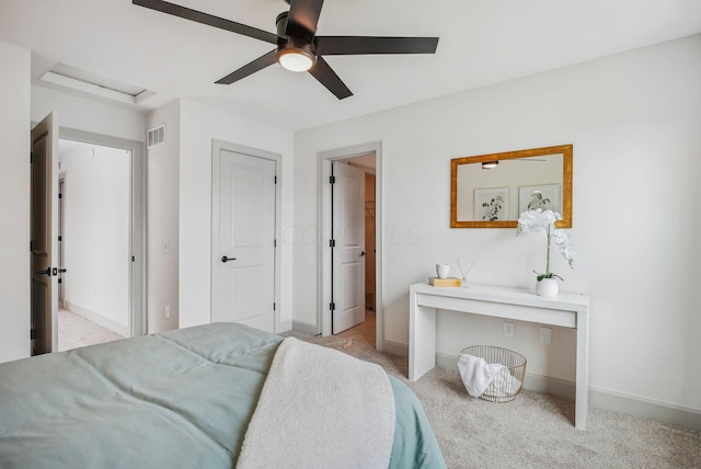 carpeted bedroom with visible vents, baseboards, and a ceiling fan