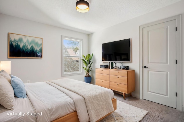 bedroom featuring light colored carpet