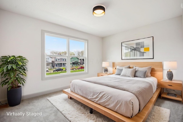 carpeted bedroom featuring baseboards