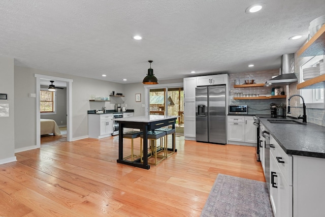 19990 Sowers Rd, Laurelville, OH 43135 - kitchen featuring a sink, open shelves, wall chimney range hood, a textured ceiling, and appliances with stainless steel finishes