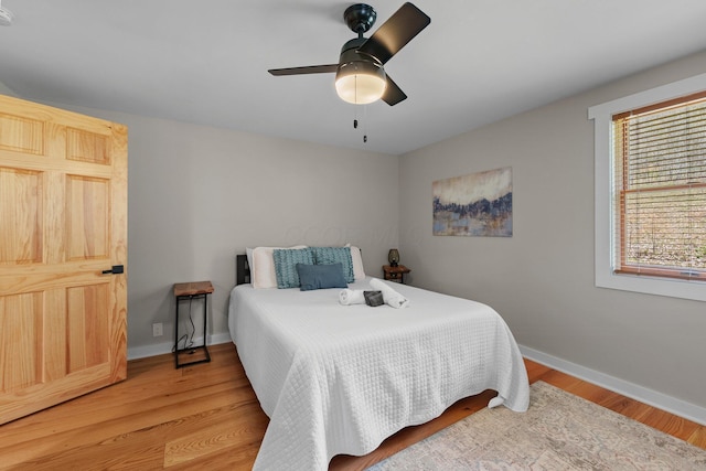 19990 Sowers Rd, Laurelville, OH 43135 - bedroom featuring baseboards, ceiling fan, and light wood-style flooring