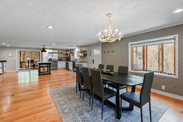 19990 Sowers Rd, Laurelville, OH 43135 - dining area with a textured ceiling, a healthy amount of sunlight, a chandelier, and baseboards