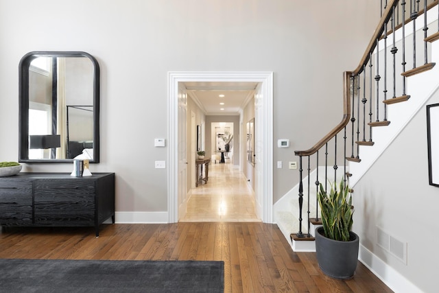 2 Albery Loop, New Albany, OH 43054 - entrance foyer with visible vents, ornamental molding, wood-type flooring, baseboards, and stairs