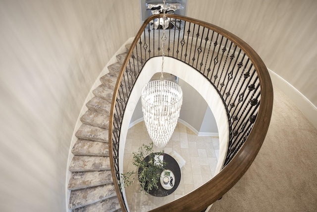 2 Albery Loop, New Albany, OH 43054 - stairway featuring baseboards, carpet, and a chandelier
