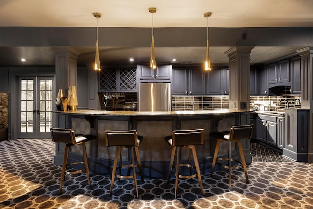 2 Albery Loop, New Albany, OH 43054 - bar featuring tasteful backsplash, stainless steel refrigerator, ornate columns, and stone floors
