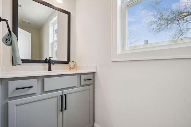 bathroom with visible vents and vanity