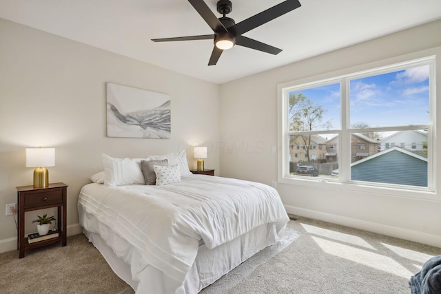 bedroom featuring baseboards, carpet floors, and ceiling fan