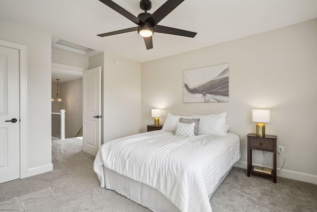 carpeted bedroom with a ceiling fan and baseboards