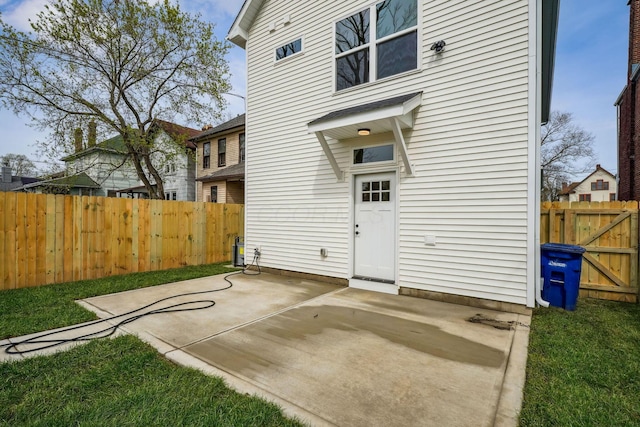 back of property featuring fence and a patio