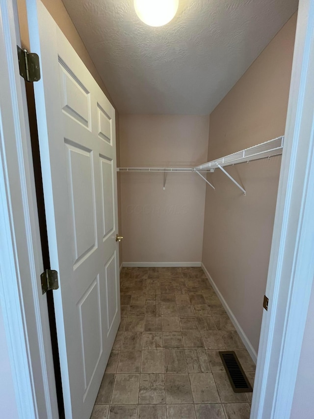 spacious closet featuring visible vents