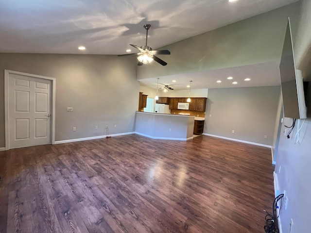 unfurnished living room with baseboards, ceiling fan, dark wood finished floors, recessed lighting, and high vaulted ceiling