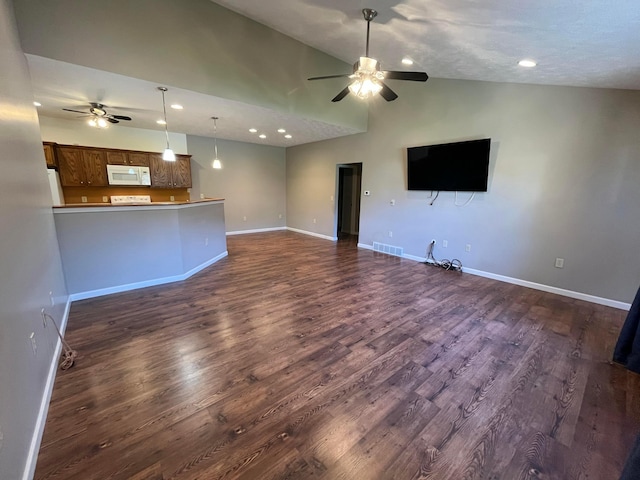 unfurnished living room featuring dark wood-style flooring, baseboards, and ceiling fan