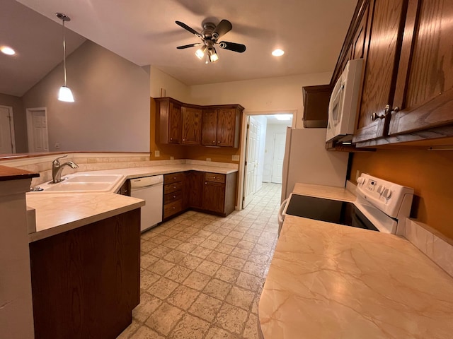 kitchen with white appliances, light countertops, a ceiling fan, light floors, and a sink