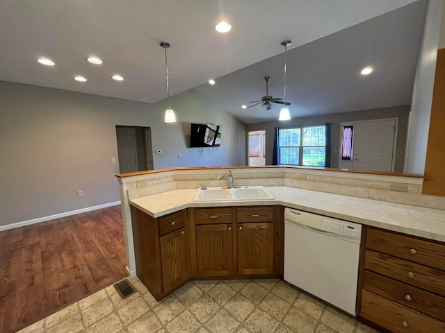kitchen featuring light countertops, brown cabinetry, ceiling fan, dishwasher, and a sink