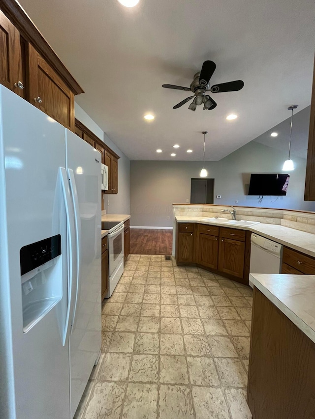 kitchen featuring a sink, light countertops, white appliances, and ceiling fan