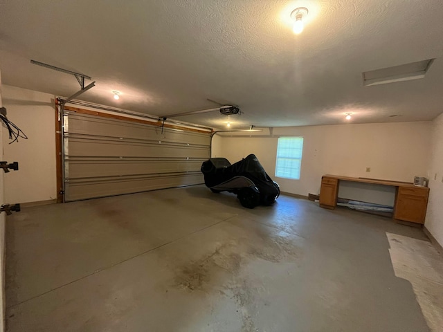 garage with baseboards and a garage door opener
