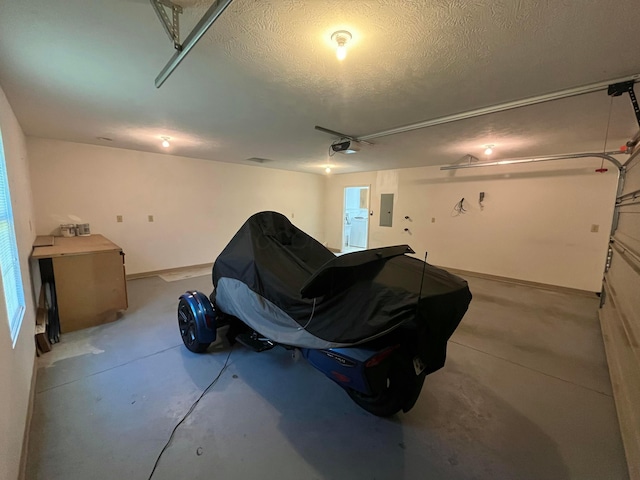 garage featuring a garage door opener and electric panel