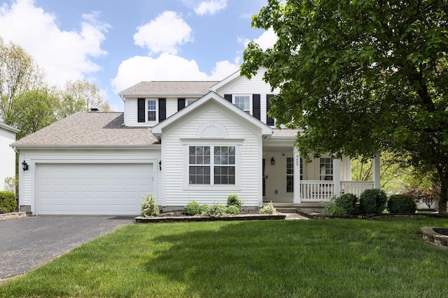 traditional-style house with driveway, covered porch, a garage, a front lawn, and roof with shingles