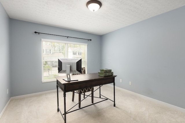 office with light carpet, healthy amount of natural light, a textured ceiling, and baseboards