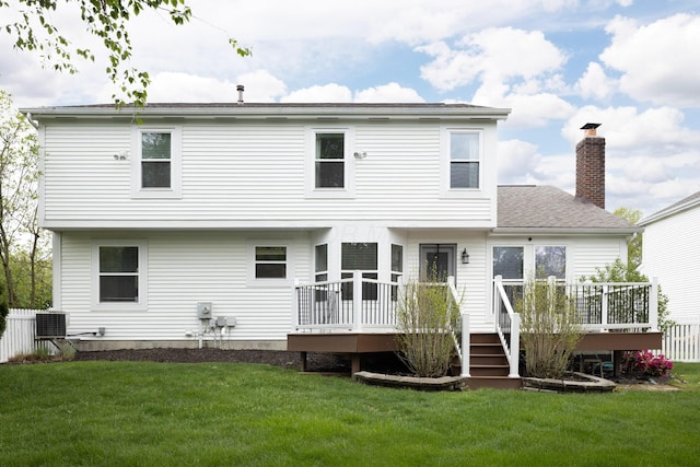 back of house with a wooden deck, a chimney, and central AC unit