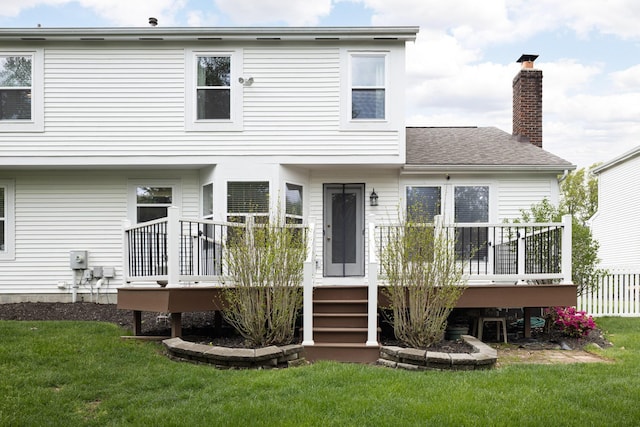 back of property featuring a deck and a chimney