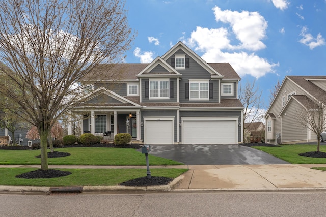 view of front of property featuring a garage, a front yard, and driveway