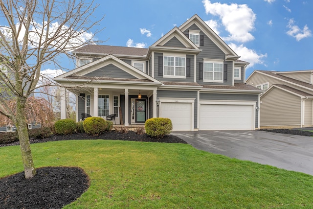 view of front facade featuring driveway, a garage, covered porch, and a front yard