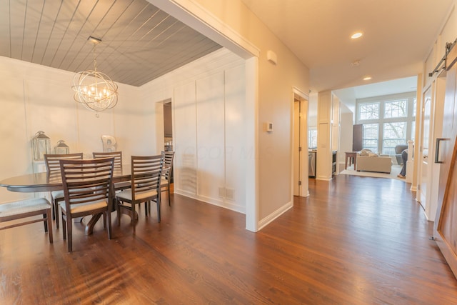 dining room with dark wood-type flooring, baseboards, recessed lighting, and a notable chandelier