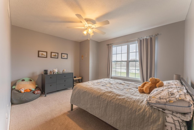 bedroom featuring light carpet and ceiling fan