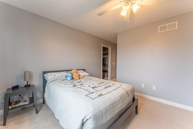 bedroom with visible vents, light colored carpet, baseboards, and a ceiling fan