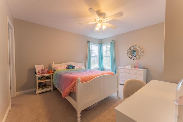 bedroom with ceiling fan, light colored carpet, and baseboards