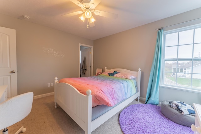 carpeted bedroom with baseboards and a ceiling fan
