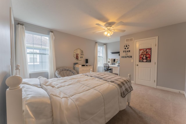 bedroom with light carpet, ceiling fan, baseboards, and visible vents